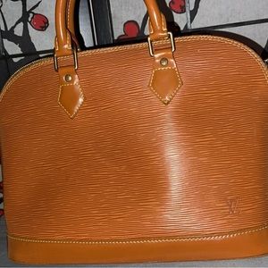 Authentic Louis Vuitton bag. Worn many times. Rip inside bag.